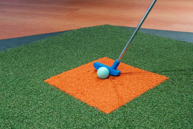 golf club and ball on a synthetic grass