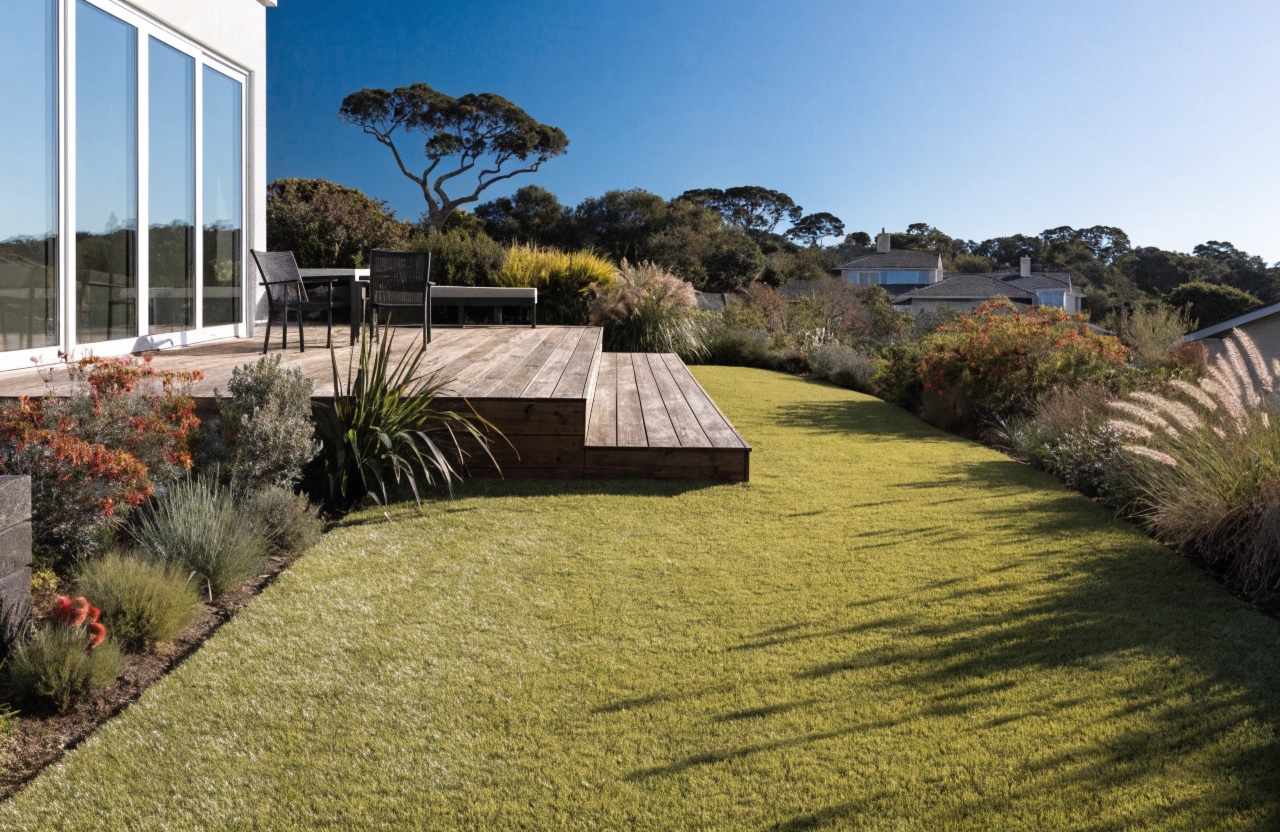 Premium artificial grass beside timber decking in a Central Coast home